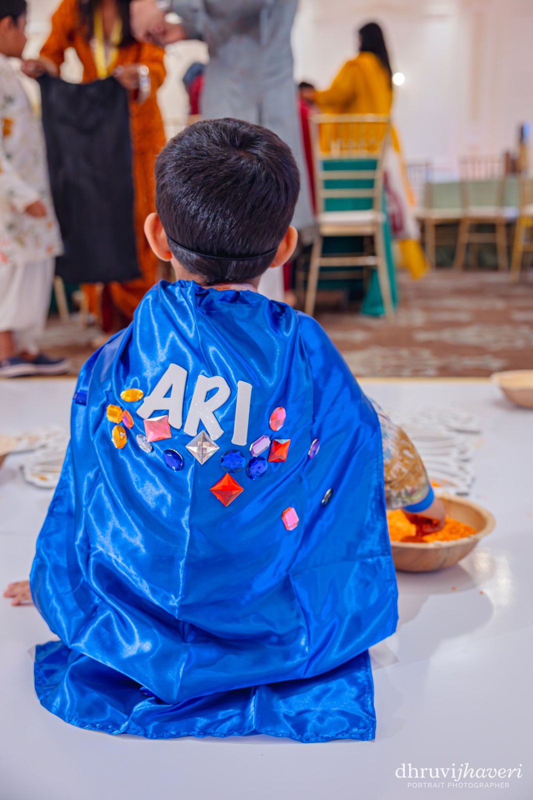 A boy in his decorated superhero cape
